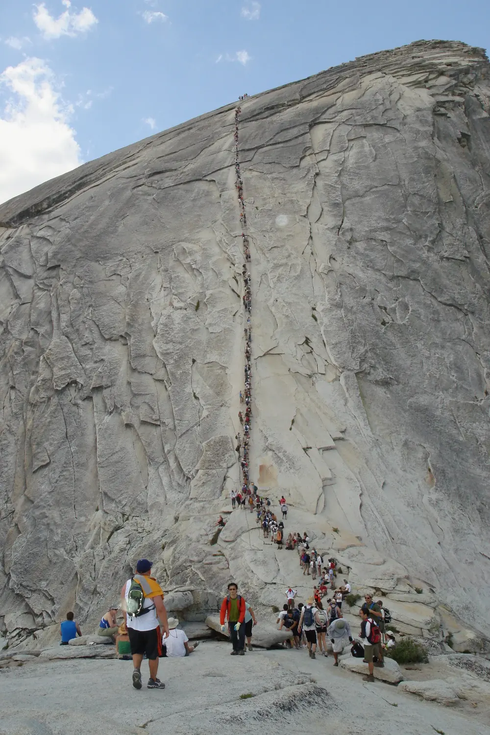 Hikers ascending the steel cables on Half Dome, Yosemite National Park